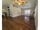Spacious living room with wood floors, natural light, and a ceiling fan at 741 Truman Ave, Lady Lake, FL 32159