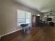 Bright living room features hard wood floors, a window and adjacent dining area at 741 Truman Ave, Lady Lake, FL 32159