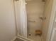 Bright shower room with a wood stool at 741 Truman Ave, Lady Lake, FL 32159