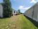 The property showcases a well-maintained side yard, offering green space between homes at 741 Truman Ave, Lady Lake, FL 32159