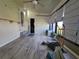 Bright sun room with laminate flooring, ceiling fan, and access to the backyard at 741 Truman Ave, Lady Lake, FL 32159