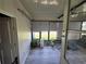 Bright sun room with laminate flooring and windows overlooking the backyard at 741 Truman Ave, Lady Lake, FL 32159