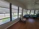 Bright sunroom with wood floors, ample windows, and comfortable seating at 741 Truman Ave, Lady Lake, FL 32159
