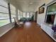 Bright sunroom with wood floors, ample windows, and comfortable seating at 741 Truman Ave, Lady Lake, FL 32159
