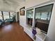 Bright sunroom with wood floors, ample windows, and comfortable seating at 741 Truman Ave, Lady Lake, FL 32159