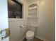 Well-lit toilet room featuring built-in shelving for toilet paper storage and decor at 741 Truman Ave, Lady Lake, FL 32159