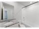 Bright bathroom featuring a granite countertop, white tiled shower-tub, and modern fixtures at 849 Teton St, Haines City, FL 33844