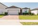 Charming single-story home with a well-manicured lawn and brick driveway at 849 Teton St, Haines City, FL 33844