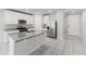 Spacious kitchen featuring granite countertops, stainless steel appliances, and a large island at 849 Teton St, Haines City, FL 33844
