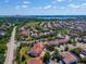 A beautiful neighborhood with mature landscaping and well-maintained homes and a view of the lake at 8625 Brixford St, Orlando, FL 32836