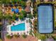 Overhead view of community featuring a playground, pool, tennis court, and landscaped grounds at 8625 Brixford St, Orlando, FL 32836