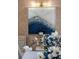 Close-up of a modern artwork displayed above a dining table with floral arrangement centerpiece at 8625 Brixford St, Orlando, FL 32836