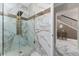Modern bathroom features marble tile, a glass shower, and gold fixtures at 8625 Brixford St, Orlando, FL 32836
