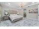Luxurious bedroom with chandelier lighting, trey ceilings, marble floors and an adjacent bathroom at 8625 Brixford St, Orlando, FL 32836