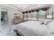 Luxurious primary bedroom with an ornate chandelier and decorative window treatments at 8625 Brixford St, Orlando, FL 32836