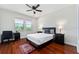 Bedroom with a decorative rug, hardwood floors, and a desk area next to the windows at 8625 Brixford St, Orlando, FL 32836