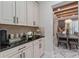 Convenient coffee bar featuring black countertops and white cabinets near the dining area at 8625 Brixford St, Orlando, FL 32836