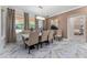 Spacious dining room with marble floors, modern lighting, and access to an adjacent bedroom at 8625 Brixford St, Orlando, FL 32836