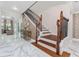 Elegant entryway showcasing marble floors, staircase with wood and iron, and stylish decor at 8625 Brixford St, Orlando, FL 32836