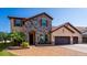 Beautiful two-story home with stone accents, a tile roof, and a three-car garage at 8625 Brixford St, Orlando, FL 32836