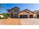 Stunning two-story home with a stone facade, tile roof, three-car garage, and brick driveway at 8625 Brixford St, Orlando, FL 32836