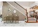 Inviting foyer showcasing marble floors, a console table, and a staircase with iron railings at 8625 Brixford St, Orlando, FL 32836