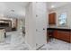Hallway with marble floors leading to a butler's pantry and a view of the living room at 8625 Brixford St, Orlando, FL 32836