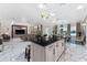 Open concept kitchen with black countertops and marble flooring at 8625 Brixford St, Orlando, FL 32836
