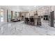 Modern kitchen features stainless steel appliances, island seating, and adjacent dining area at 8625 Brixford St, Orlando, FL 32836