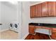 Laundry room with dark wood cabinets and counters, and washer and dryer at 8625 Brixford St, Orlando, FL 32836