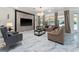 Spacious living room featuring marble floors, modern lighting, and neutral-toned furniture at 8625 Brixford St, Orlando, FL 32836