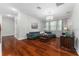 Living room with hardwood floors, modern chandelier, and ample natural light at 8625 Brixford St, Orlando, FL 32836