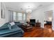 Living room featuring stylish blue sofa set, dark wood flooring, and modern lighting at 8625 Brixford St, Orlando, FL 32836