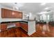 Open space featuring dark wood cabinets and floors with views to living room at 8625 Brixford St, Orlando, FL 32836