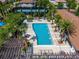 Aerial shot of the community pool with lounge chairs, tables, cabana, and lush landscaping at 8625 Brixford St, Orlando, FL 32836