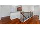 Stairway with dark wood floors and railing and a view to the living space at 8625 Brixford St, Orlando, FL 32836