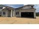 An unfinished exterior of a single-Gathering home shows the block construction and attached two-car garage at 873 Pointe Emerson Blvd, Apopka, FL 32703