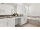 Bright bathroom features dual sink vanity, bathtub, and ample storage, creating practical and stylish space at 9179 Sommerset Hills Dr, Davenport, FL 33896