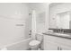 Well-lit bathroom with shower-tub combination, and ample counter space, offering practical and serene environment at 9179 Sommerset Hills Dr, Davenport, FL 33896