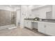 Elegant bathroom with dual vanity, walk-in shower, and serene ambiance, offering luxurious retreat at 9179 Sommerset Hills Dr, Davenport, FL 33896
