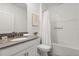 Clean bathroom with a single sink vanity, framed mirror, and shower with a tub at 9179 Sommerset Hills Dr, Davenport, FL 33896