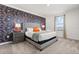 Bedroom features gray upholstered bed, vibrant wallpaper, and natural light creating cozy and inviting space at 9179 Sommerset Hills Dr, Davenport, FL 33896