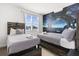 Bedroom with twin beds, custom headboards, and unique space mural, creating cozy and imaginative retreat at 9179 Sommerset Hills Dr, Davenport, FL 33896