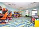 Spacious game room featuring an array of arcade games and a pool table for residents to enjoy at 9179 Sommerset Hills Dr, Davenport, FL 33896