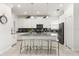 Modern kitchen with white cabinets, gray countertops, stainless steel appliances, and a center island at 9179 Sommerset Hills Dr, Davenport, FL 33896