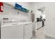 Well-equipped laundry room with modern appliances and easy access to kitchen at 9179 Sommerset Hills Dr, Davenport, FL 33896