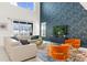 Bright living room with high ceilings, modern furniture, and a sliding glass door to the backyard at 9179 Sommerset Hills Dr, Davenport, FL 33896