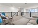 Upstairs loft offers seating, stylish railing, and views, creating welcoming and versatile living space at 9179 Sommerset Hills Dr, Davenport, FL 33896