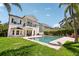 Exterior view of the house with a spacious lawn, lush landscaping and a private pool at 9684 Sweetleaf St, Orlando, FL 32827