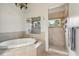 Beautiful bathroom featuring an alcove tub and a glass door shower at 9684 Sweetleaf St, Orlando, FL 32827